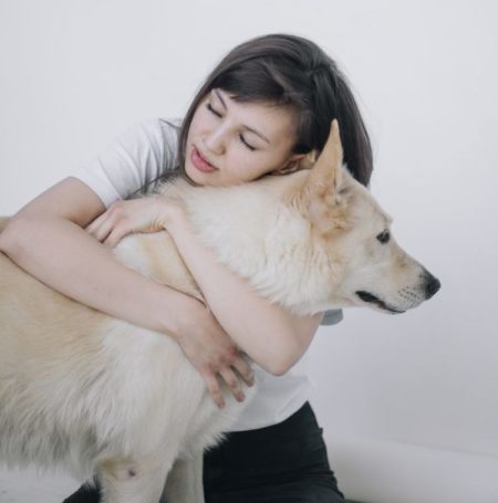 girl hugging dog