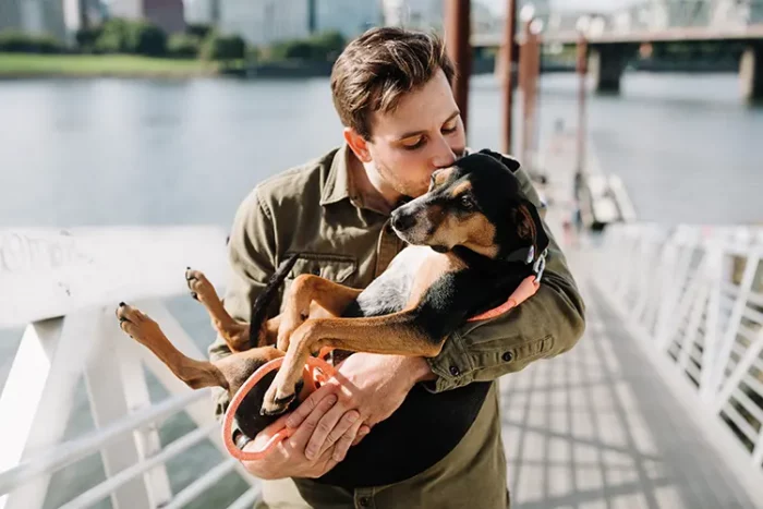 Service dog owner embracing his service dog
